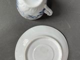 a small cup and saucer sitting on a table