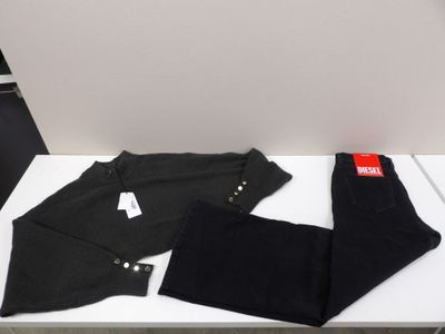 two pairs of black pants sitting on top of a white table