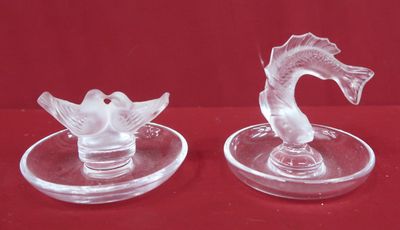 pair of clear glass swan candlestick holders on red background