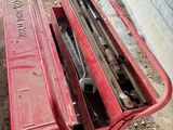 a red tool box sitting on top of a pile of tools