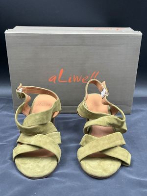 une paire de sandales en daim vert pour femme, avec une boîte