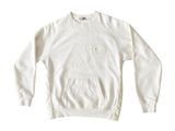 the sweatshirt is white and has a pocket on the front