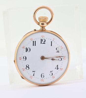 a gold pocket watch with a white face and numbers on it