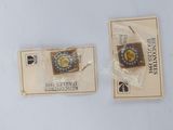 two small badges on the back of a card
