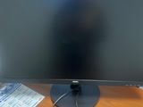 a computer monitor sitting on a desk with a mouse and keyboard