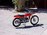 a red dirt bike parked on the side of the road