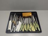 a tray with knives and a block of wood on it