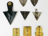 several pieces of metal and brass are arranged on a white surface