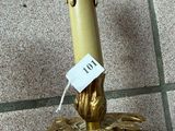 a candle that is sitting on the floor with a price tag on it