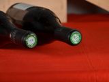 two bottles of wine sitting on a red table