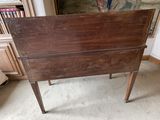 a small wooden table with a mirror on it