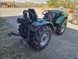 a tractor that is parked on the side of the road