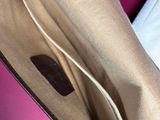 a bag that is open on a pink surface
