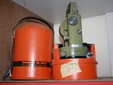 two orange buckets sitting on top of a shelf next to a green machine