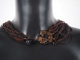 brown and black beaded necklace on mannequin mannequin mannequin mannequin mannequin mannequin mannequin mannequin mann