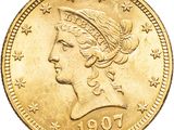 a close up of a gold coin with a woman ' s head on it