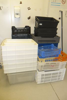 many plastic containers stacked on top of each other in a room