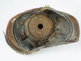 a close up of a broken shoe on a white surface