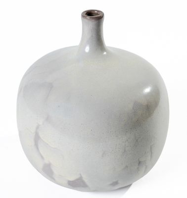 a white vase that is sitting on a white surface