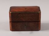 a small wooden box with a lid on a white surface