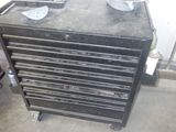 a black tool cabinet with a pair of shoes on top of it