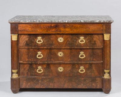 an antique chest of drawers with marble top and brass handles