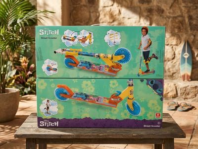 a box with a toy scooter sitting on a table