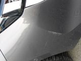 a close up of a car ' s front bumper and tire