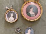 three miniature portraits of women are displayed in a gold frame on a table