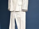 a white suit on a mannequin stand on a blue background
