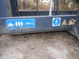 a blue sign on the side of a metal fence