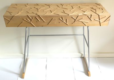 a wooden table with sticks on it in a room