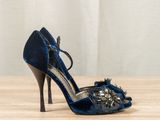 a close up of a pair of blue shoes on a wooden table