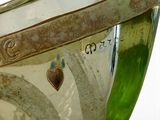 a green glass vase with a heart on it