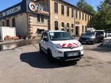 a small white car parked in front of a building