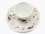 a small cup and saucer on a saucer