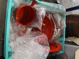 a plastic container filled with plastic cups and plates