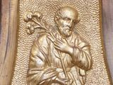 a statue of a man holding a flower in his hand
