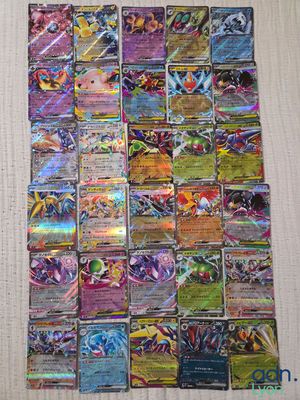 a pile of pokemon cards sitting on top of a table