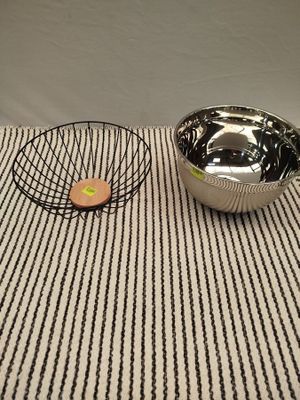 un saladier et un panier en fil de fer posés sur une table