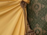 a yellow umbrella hanging on a wall next to a green wall