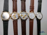 several different types of watches are lined up on a white surface