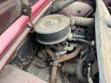 a small engine in the back of an old truck