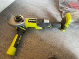 the corded tool is sitting on the floor next to a plastic bag