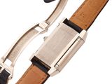 a close up of a watch on a white background with a black strap