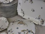 many plates and bowls that are sitting on a table