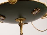 a chandelier hanging from a ceiling with a bird on it