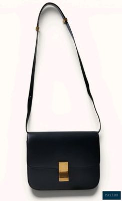 a black bag with a gold buckle on the front