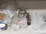a shelf that has many glasses and plates on it
