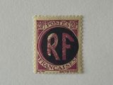 a close up of a stamp with the letter r on it